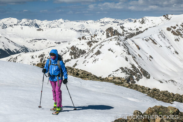Christy skinning up the ridge to the summit of 13736