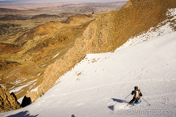 Aaron skis down towards the entrance to the couloir.