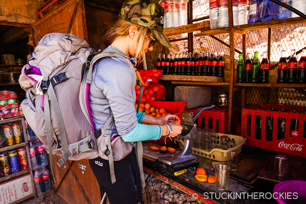 Christy squeezing oranges along the trail