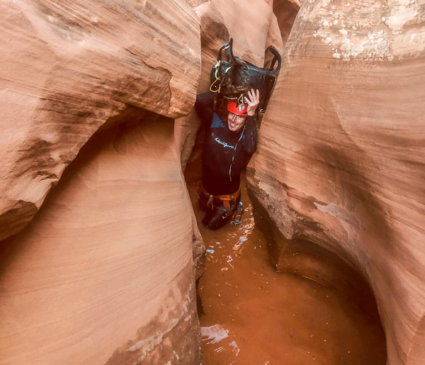 Ted Mahon working through  a squeeze in High Spur canyon