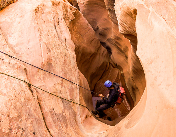 Rappelling down into a section of narrows in a slot canyon.